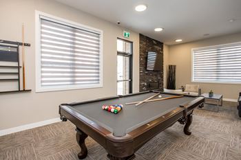 A pool table with a few balls and a cue stick on it.